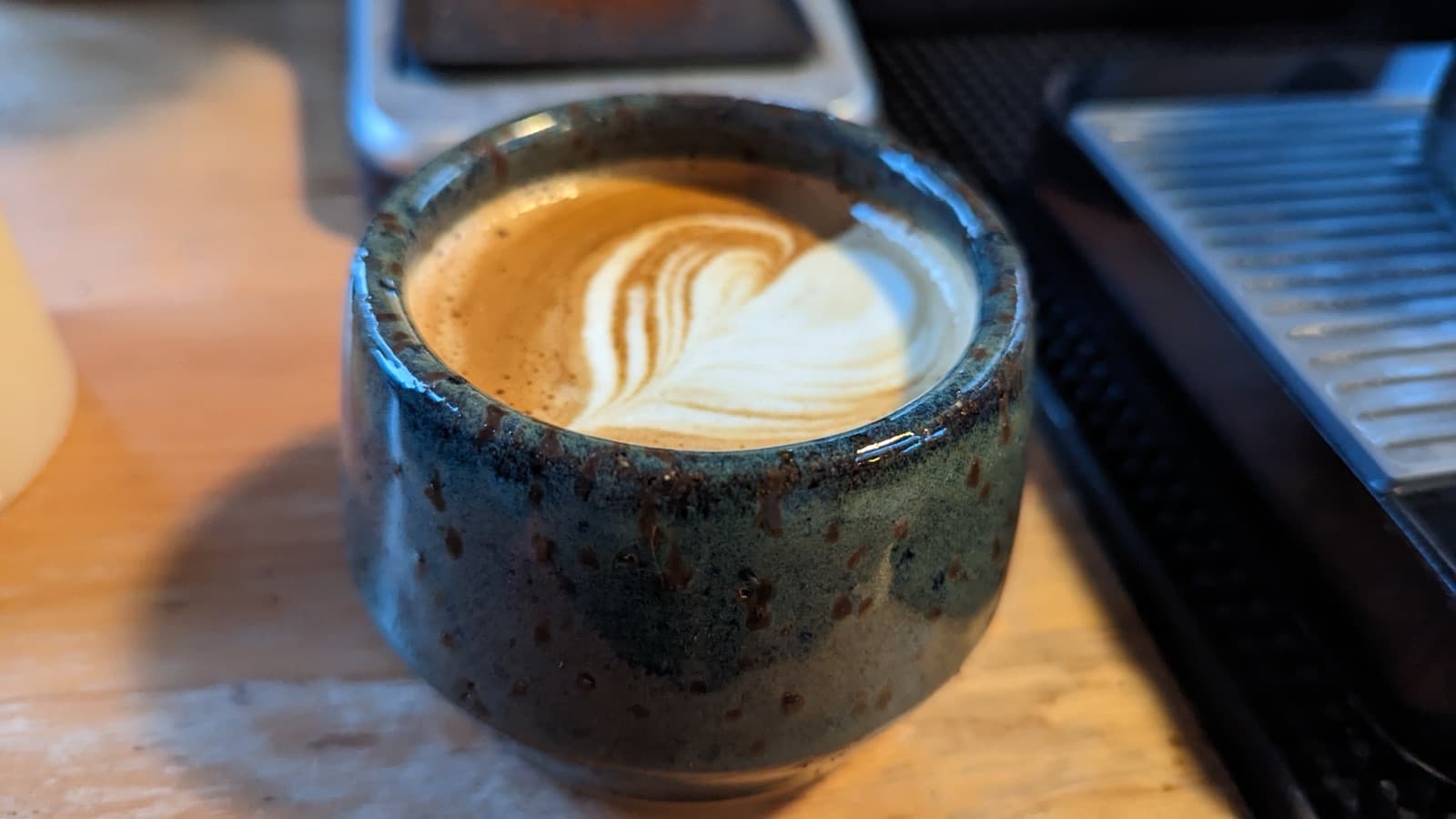 Latte art in a handmade ceramic cup